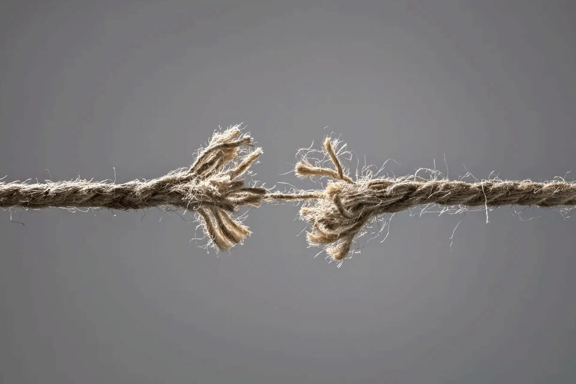 An image of a frayed rope about to break