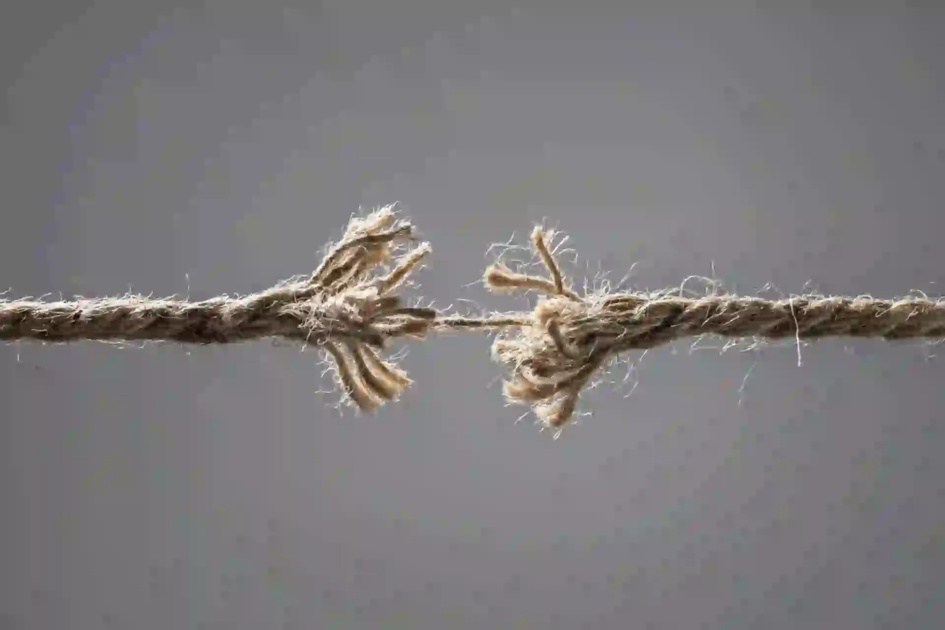 An image of a frayed rope about to break