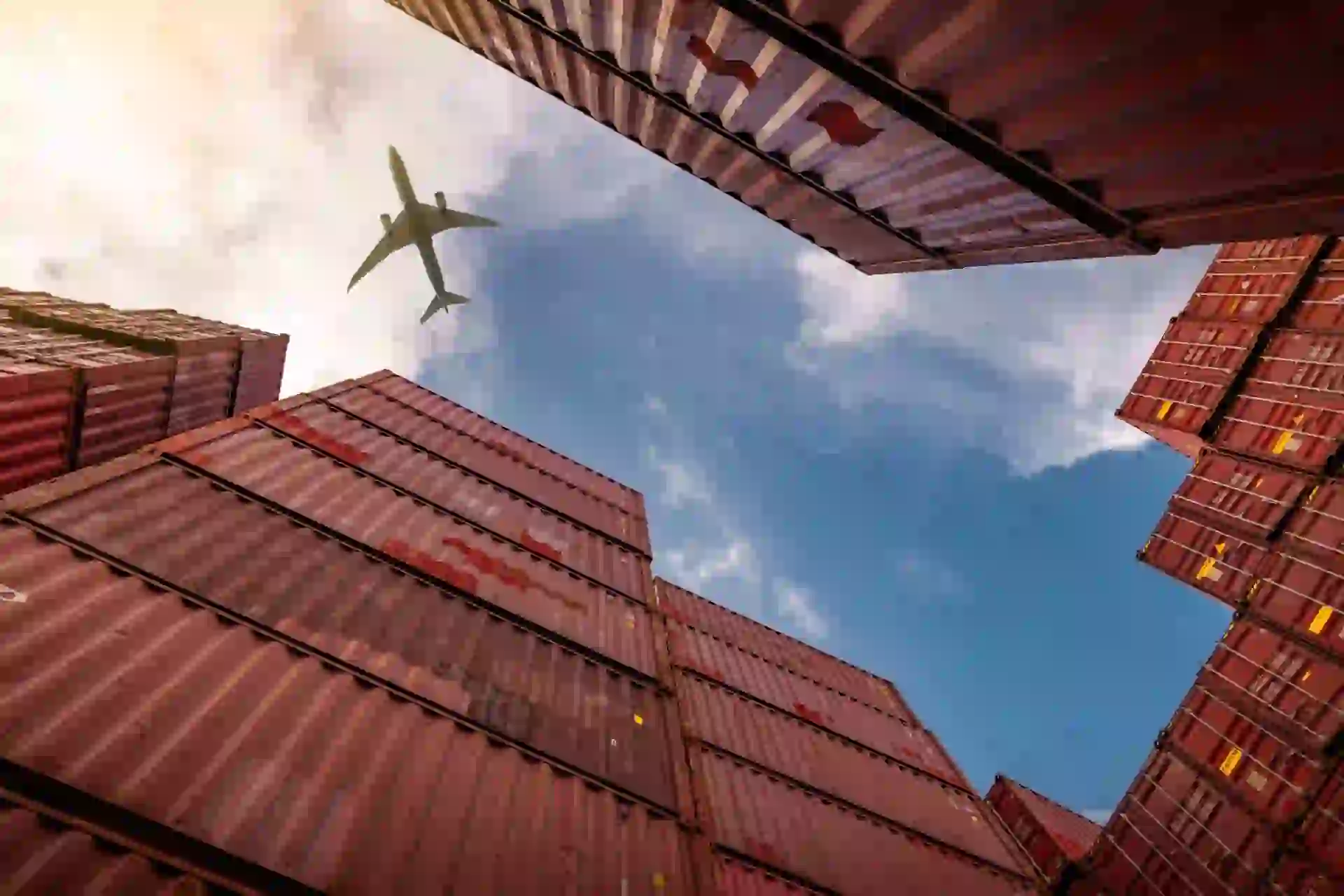 A stylised image showing many shipping containers and a plan in the sky