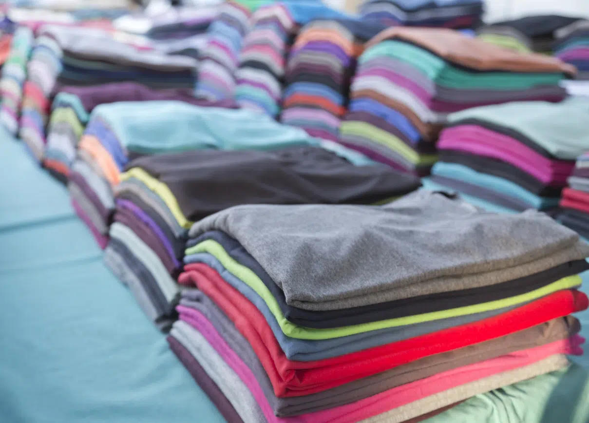 Piles of colorful and new folded basic t-shirts