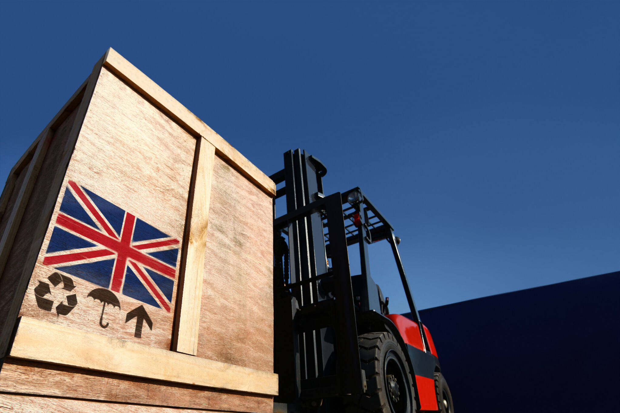 Forklift truck with boxes on pallet with union jack flag logo