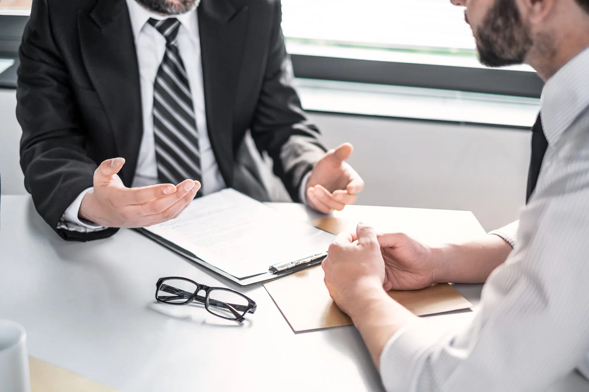 Business people negotiating a contract. Human hands working with documents at desk and signing contract.